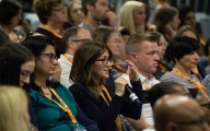 Description_of_image_used_in_five_reasons_for_social_work_managers_to_be_at_Community_Care_Live_woman_putting_question_in_session_Gary_Brigden