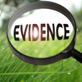 Description_of_image_used_in_if telecare_doesn't_work_then_why_are_councils_still_using_it_magnifying_glass_over_word_evidence